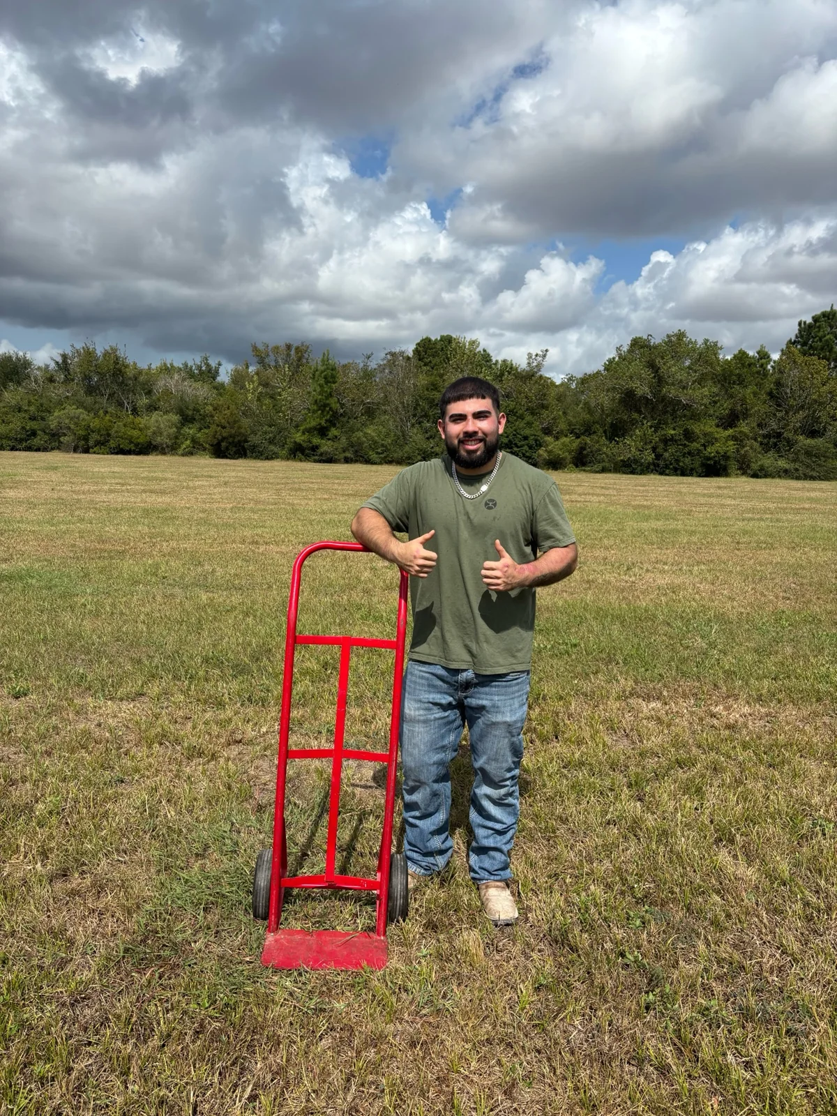 AOA team member with the red hand truck used for hauling