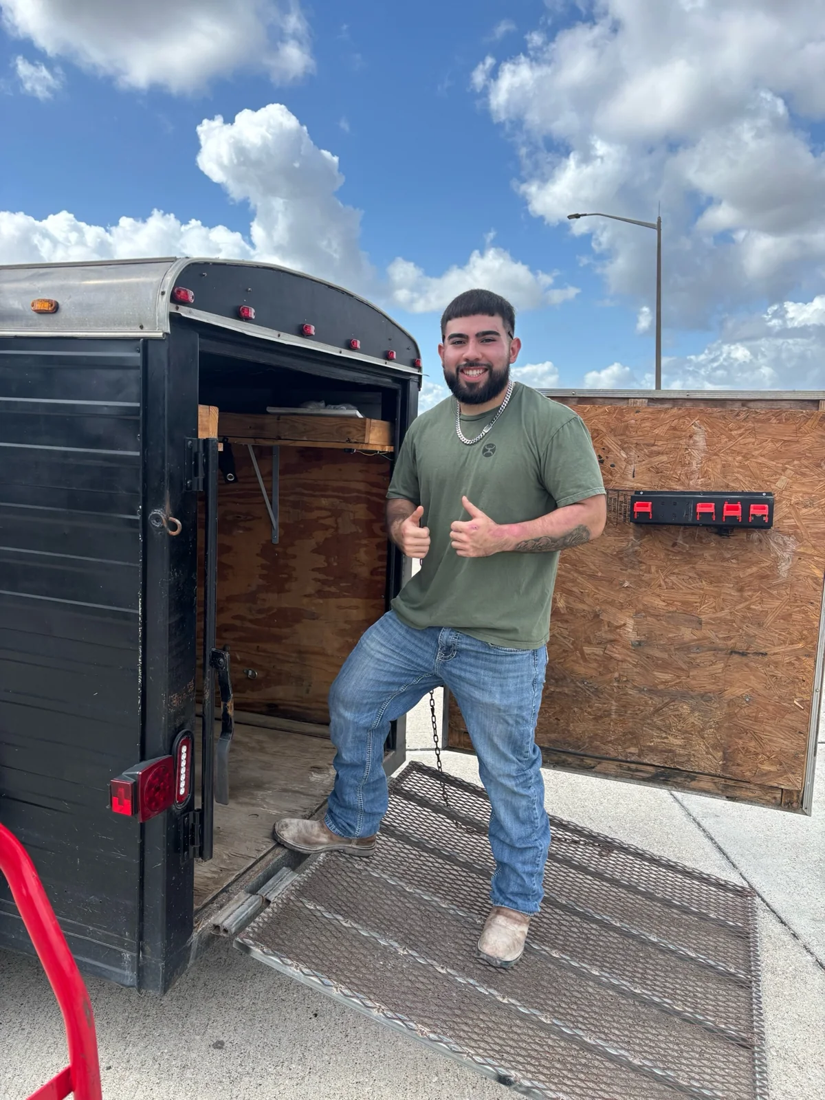 AOA crew member standing ready at the open trailer ramp