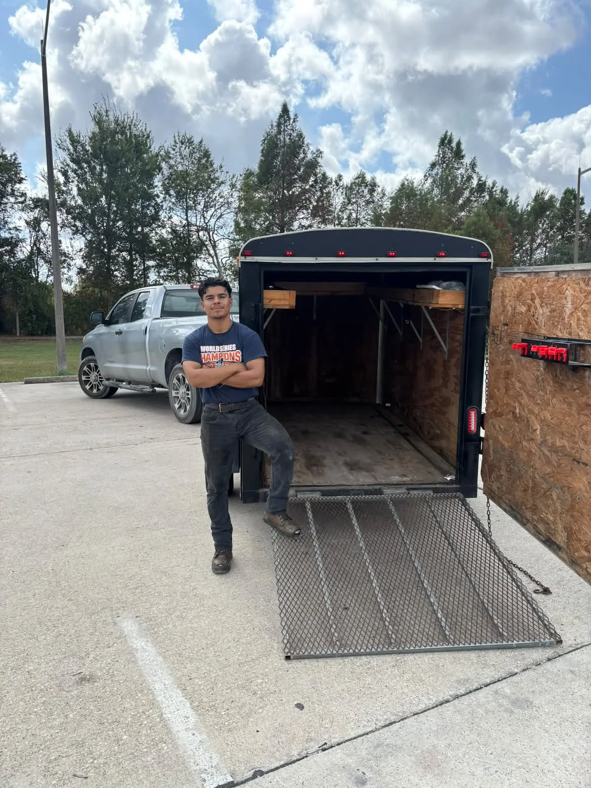 An AOA team member beside the hauling trailer and pickup truck